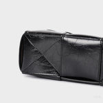 Black Glossy Woven Handbag — Modern structure with elevated shine