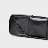 Black Glossy Woven Handbag — Modern structure with elevated shine