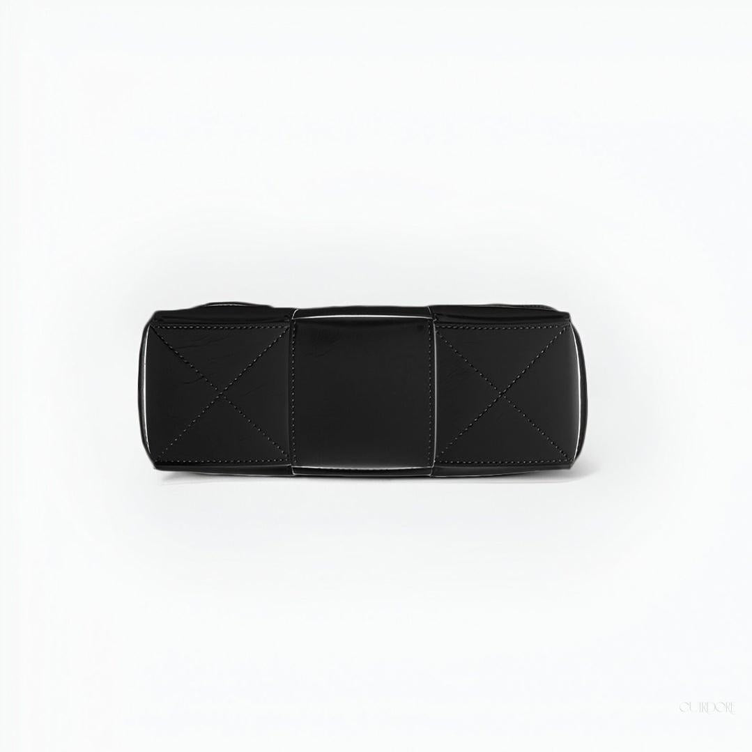 Black Glossy Woven Handbag — Modern structure with elevated shine