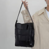 Black Glossy Woven Handbag — Modern structure with elevated shine