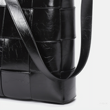 Black Glossy Woven Handbag — Modern structure with elevated shine